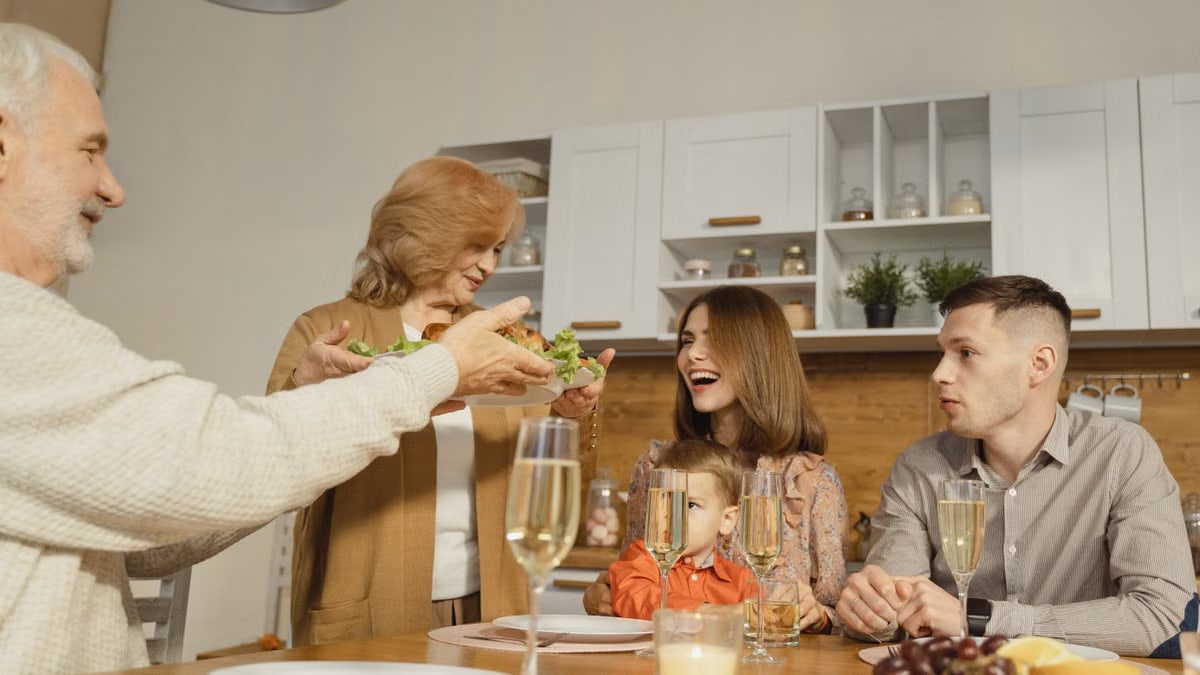 A multigenerational family enjoying a festive dinner indoors, sharing joy and togetherness.